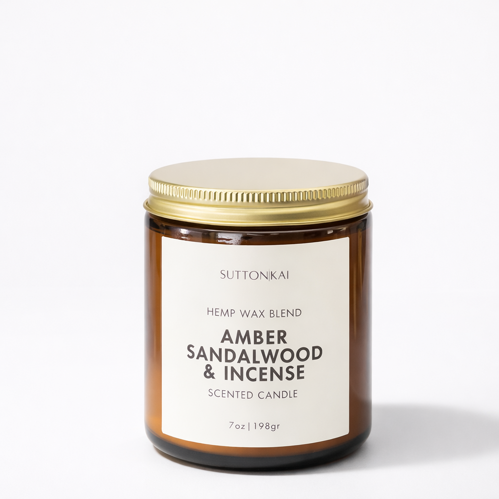 Suttonkai amber sandalwood and incense scented candle with a gold lid on a white background