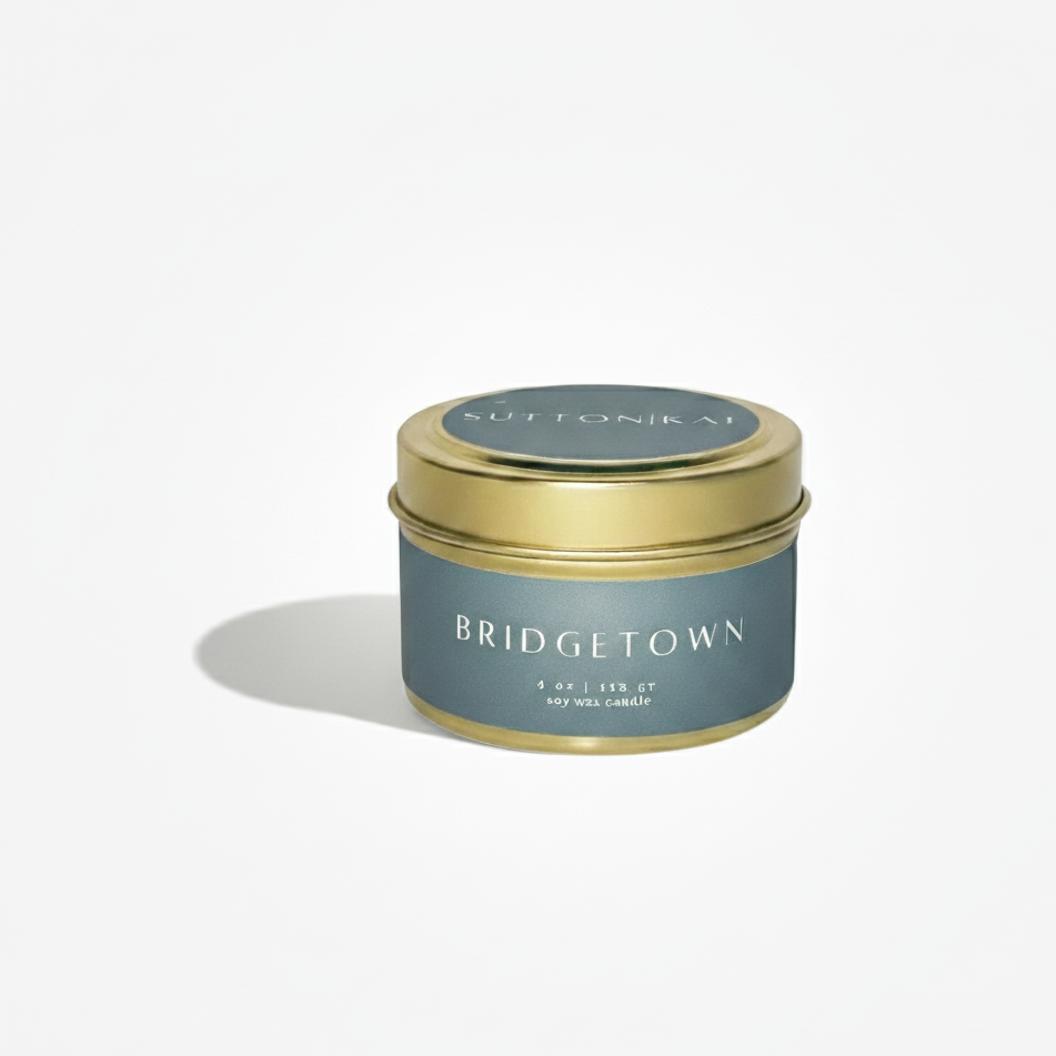 Candle tin labeled 'Bridgetown' with a gold lid on a white background
