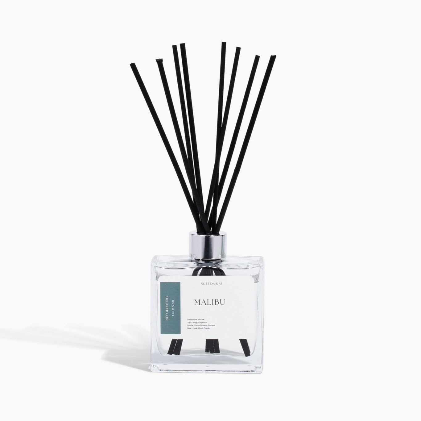 Reed diffuser with black sticks on a white background