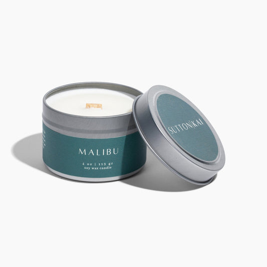 Candle in a tin with 'Malibu' branding on a white background