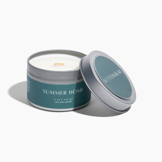 Candle in a teal container with 'Summer Home' text on a white background