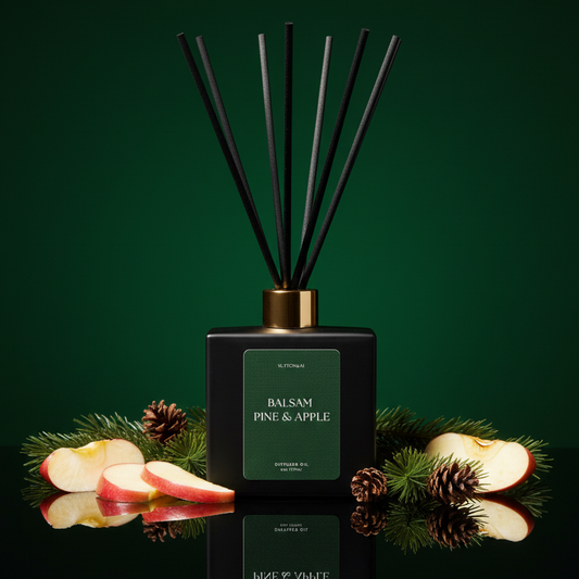 Black diffuser bottle labeled 'Balsam Pine & Apple' with decorative elements on a dark green background