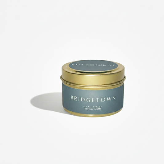 Candle tin labeled 'Bridgetown' with a gold lid on a white background