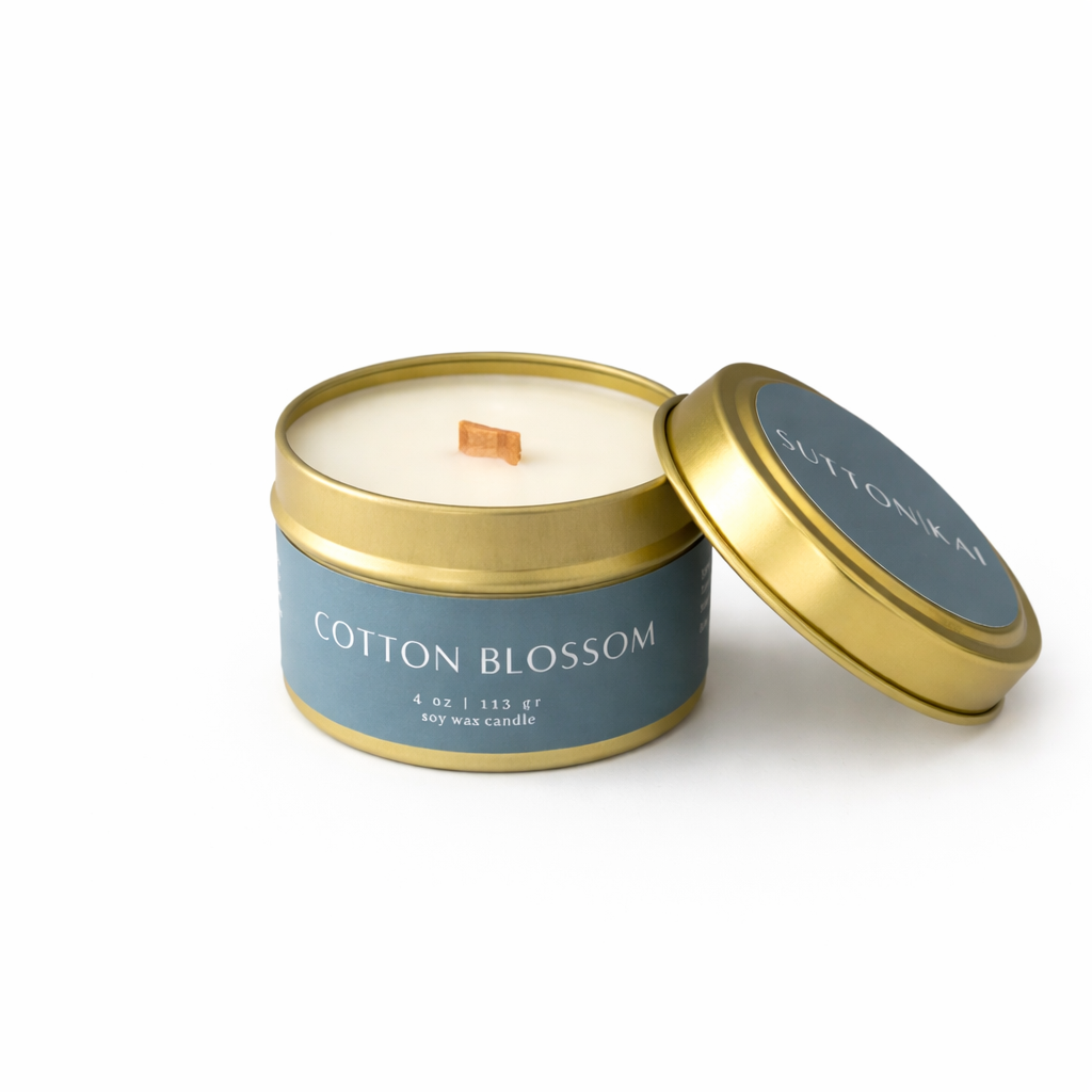 Cotton Blossom Wooden Wick Candle | Clean & Fresh Scent in a gold tin with a blue label on a white background