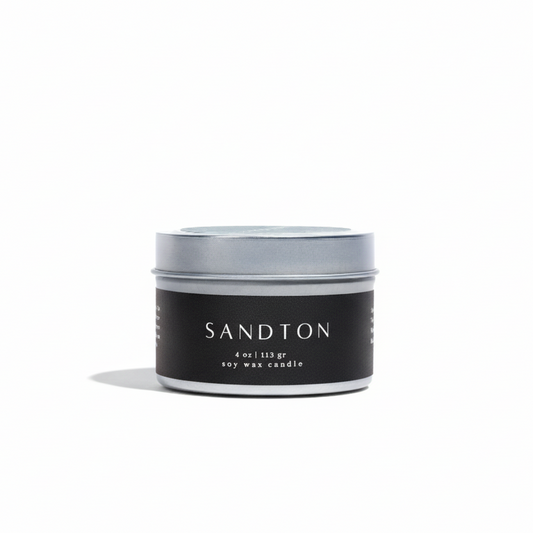 Candle jar with 'Sandton' branding on a white background