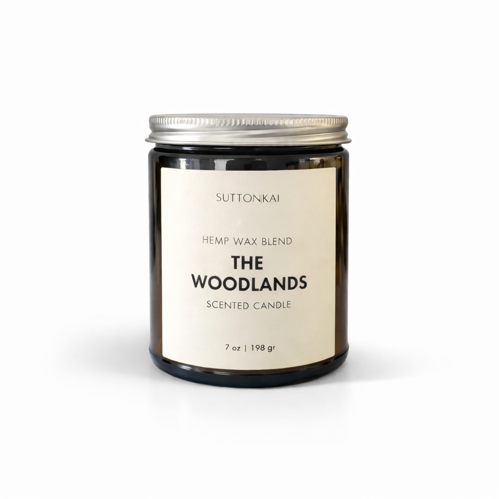 Suttonkai candle labeled 'The Woodlands' on a white background